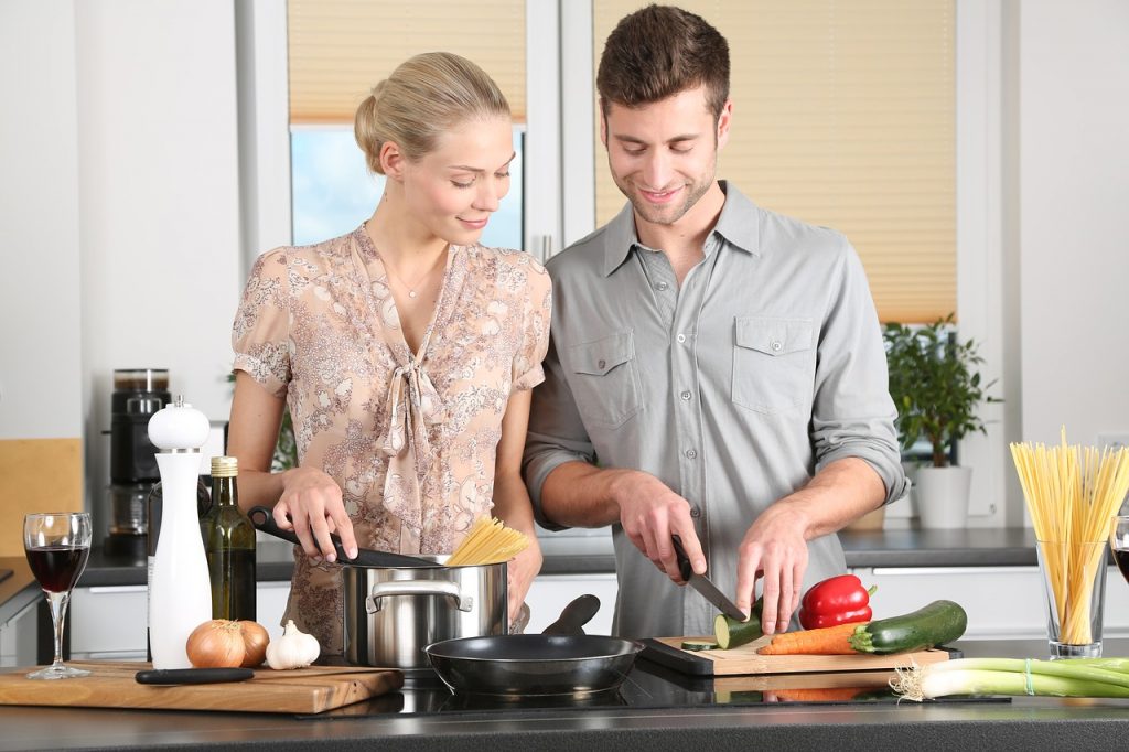 man and woman preparing a meal