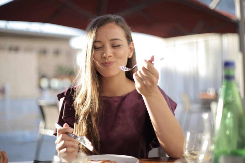 woman eating and focusing on her food sensation