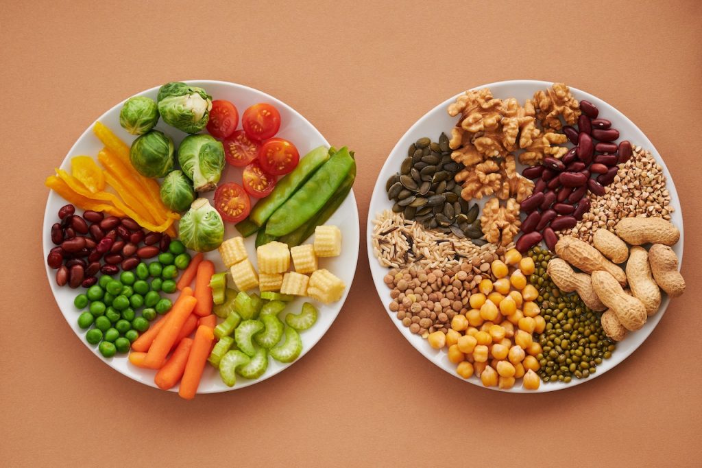 image of two plates presenting vegetables and nuts and starchy foods
