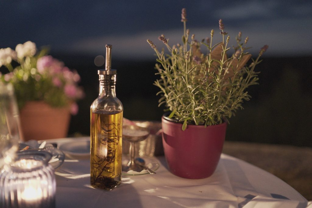 A bottle of olive oil on a table to consume lipids